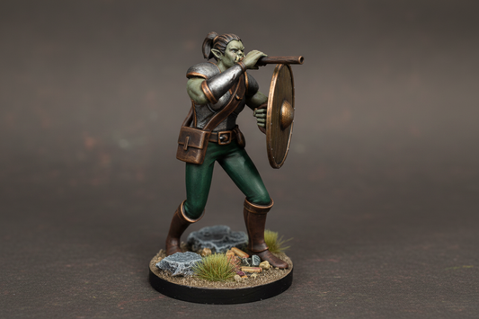 Miniature figurine of a warrior with armor and shield on a dark gray background